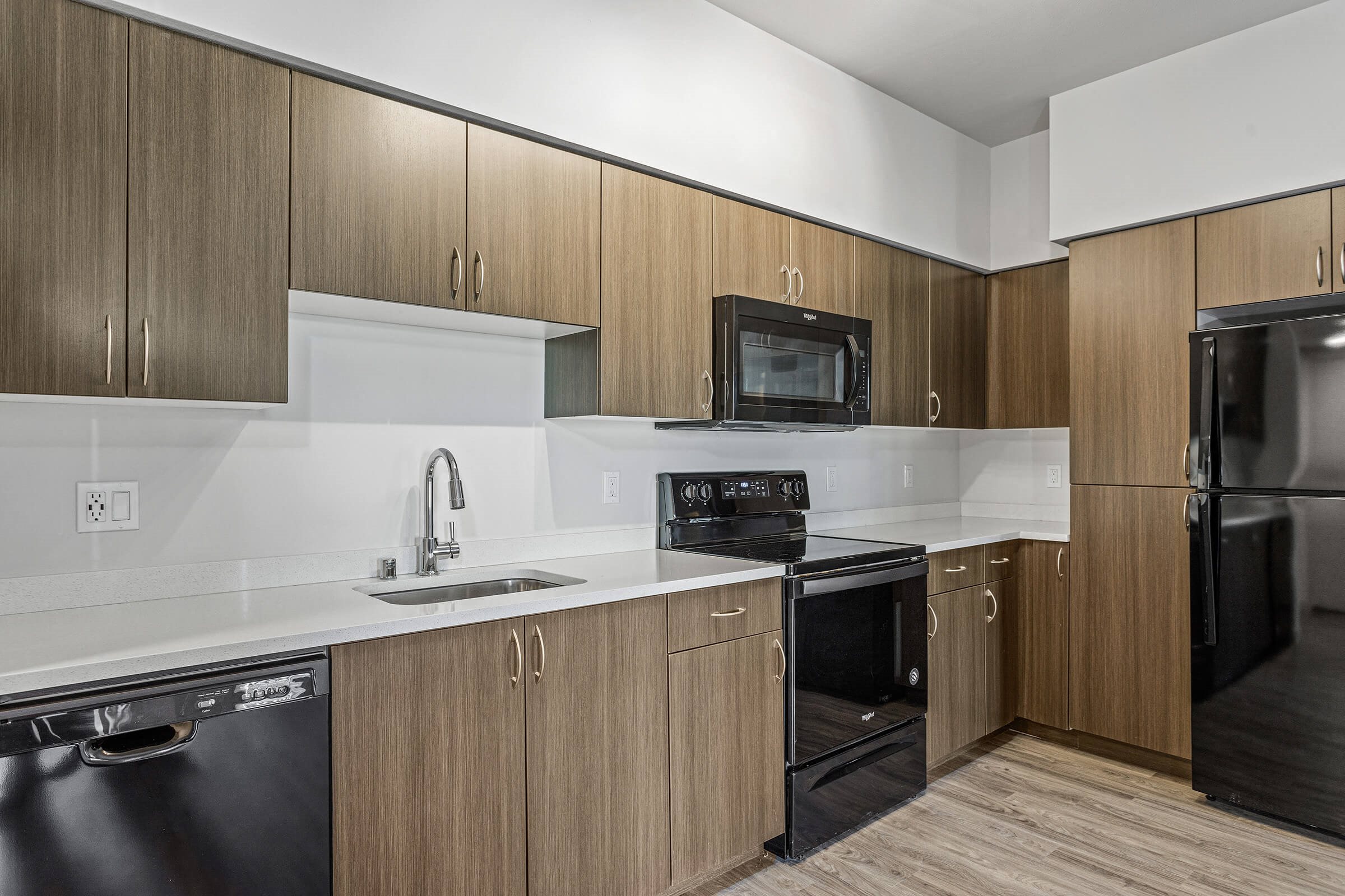 Kitchen with wood cabinets at GEO Apartment in Fremont CA